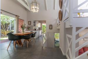 a dining room and kitchen with a table and chairs at Silvermist Organic Wine Estate in Cape Town