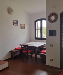 a room with a table and chairs and a window at Casa Sofia in Torre delle Stelle +16 photos