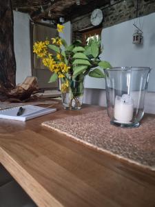 a table with a candle and a vase with flowers at Pace attraverso gli occhi in Perledo +70 photos