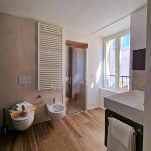 a bathroom with a toilet and a sink and a shower at Locanda Mimmo in Bergamo