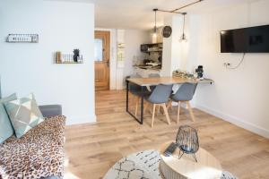 a living room with a couch and a table at Studio tout confort proche des thermes in Vals-les-Bains