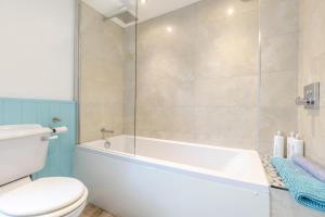 a bathroom with a white tub and a toilet at 3 Bed in Tideswell oc-w39004 in Tideswell +12 photos