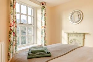 a bedroom with a bed with a window and two towels at 3 Bed in Tideswell oc-w39004 in Tideswell