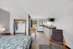 a bedroom with a bed and a kitchen with a table at 1 Bed in Minsterley oc-s38642 in Minsterley