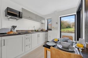 a kitchen with a table and a dining room at 1 Bed in Minsterley oc-s38641 in Minsterley +9 photos