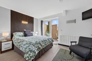 a bedroom with a bed and a chair at 1 Bed in Minsterley oc-s38641 in Minsterley