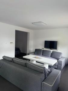 a living room with a couch and a table at TOBI-pokoje gościnne in Łeba