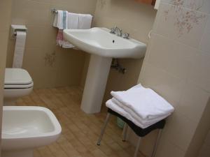 a bathroom with a sink and a toilet at Hotel Cristallo Cesenatico in Cesenatico