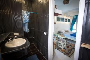 a bathroom with a sink and a bedroom with a bed at Skyrock Dahab in Dahab +58 photos