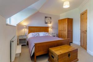 a bedroom with a large bed with a wooden bed frame at 2 Bed in Reydon oc-s39034 in Reydon