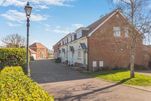 a street with houses and a light pole on a street at 2 Bed in Reydon oc-s39034 in Reydon