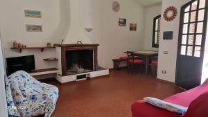 a living room with a couch and a fireplace at Casa Sofia in Torre delle Stelle