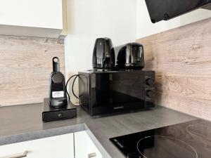 a microwave sitting on a kitchen counter with a phone at Feel like Home 8 in Biberach an der Riß