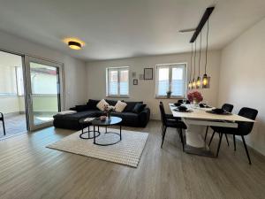 a living room with a black couch and a table at Feel like Home 8 in Biberach an der Riß