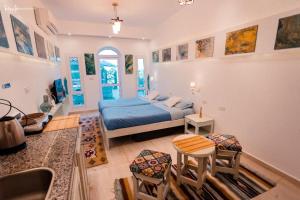 a bedroom with a bed and a sink in it at Skyrock Dahab in Dahab