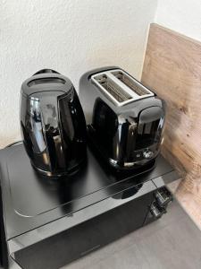 a black toaster sitting on top of a stove at Feel like Home 8 in Biberach an der Riß +17 photos