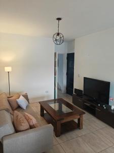 a living room with a couch and a coffee table at Balcón de Lourdes in Santos Lugares