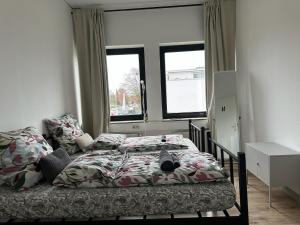 a bedroom with a bed and a window at Boberger Hostel in Hamburg
