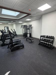 a gym with treadmills and exercise equipment in a room at Ramada by Wyndham Cobleskill in Cobleskill
