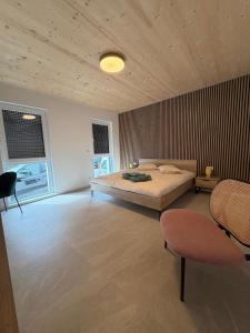 a bedroom with a bed and two chairs in it at NEW - Mullerthal Basecamp - Sleeps 6 in Beaufort