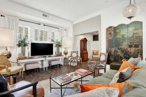 a living room with a couch and a tv at The Stables in Savannah