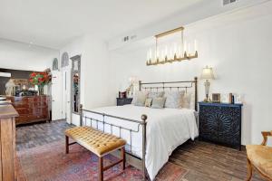 a bedroom with a bed and a bench in a room at The Stables in Savannah +68 photos