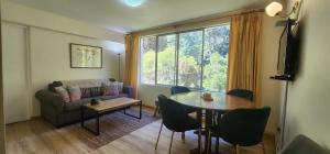 a living room with a table and a couch at Departamento en Playa Las Cadenas in Algarrobo
