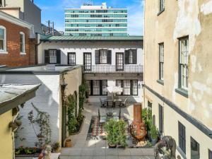 an apartment balcony with a patio and a building at The Stables in Savannah