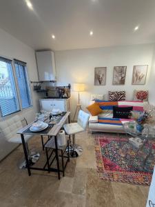 a living room with a couch and a table at 13th private in Rueil-Malmaison