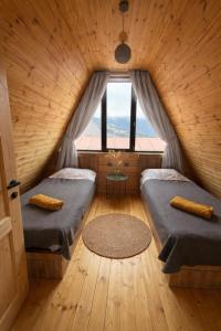a room with two beds and a window at Mestia Inn Chalet in Mestia