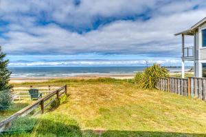 a beach house with a view of the ocean at Inviting dog-friendly studio with unobstructed ocean views in Bandon