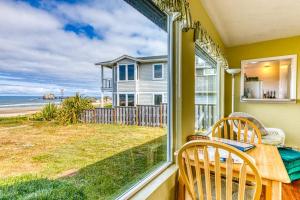 a dining room with a table and chairs and a view of the ocean at Inviting dog-friendly studio with unobstructed ocean views in Bandon