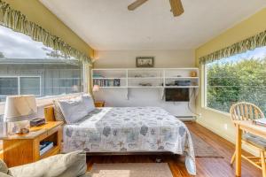 a bedroom with a bed and a large window at Inviting dog-friendly studio with unobstructed ocean views in Bandon
