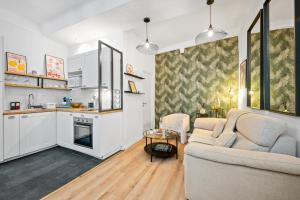 a living room with a couch and a table at Sky Lodge - Vieux Nice in Nice +14 photos