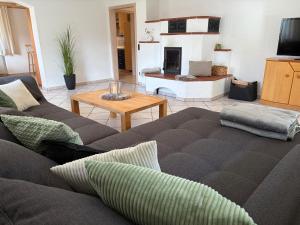 a living room with a couch and a fireplace at Ferienwohnung Ottenzeller Haisl in Arrach
