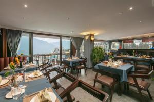 a restaurant with tables and chairs with a view at Sapa Horizon Hotel & Skybar in Sapa