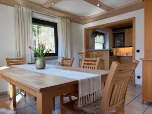 a kitchen and dining room with a table and chairs at Ferienwohnung Ottenzeller Haisl in Arrach +13 photos