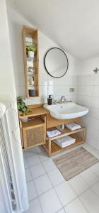 a white bathroom with a sink and a mirror at Villa Rosetta in Airasca