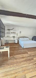 a bedroom with two beds and a desk and a tv at Villa Rosetta in Airasca