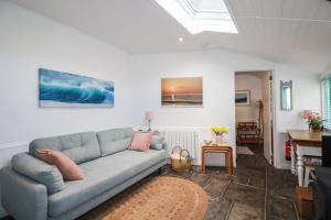 a living room with a couch and a table at Smugglers Cottage in Tintagel