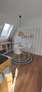 a kitchen with a table and chairs in a room at Uns Lüttje in Norden +8 photos
