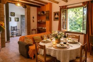 a living room with a table and a couch at Complejo El Alambique in Algatocín +33 photos
