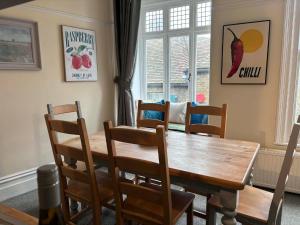 a dining room with a wooden table and chairs at The Old Bakery in Sandwich
