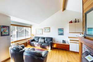 a living room with a couch and a table at Charming oceanfront cottage with WiFi & easy beach access in Cannon Beach