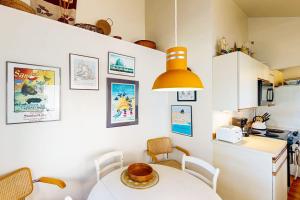 a small kitchen with a table and a refrigerator at Charming oceanfront cottage with WiFi & easy beach access in Cannon Beach