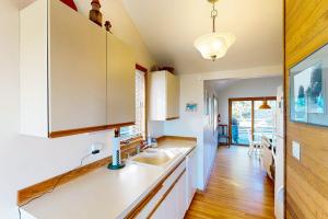 a kitchen with a sink and a counter top at Charming oceanfront cottage with WiFi & easy beach access in Cannon Beach +9 photos