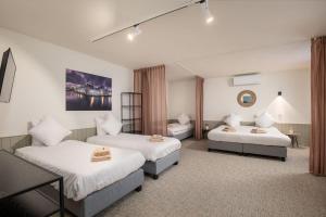 a hotel room with two beds and a mirror at Hotel Augustyn Brugge in Bruges +76 photos