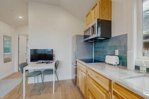 a kitchen with a table and chairs and a counter top at Dog-friendly comfy cabin only two blocks from the beach in Cannon Beach