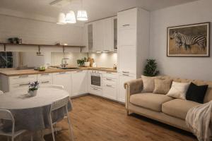 a kitchen and living room with a couch and a table at 3 Rooms Garden Parking in Raszyn