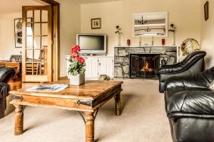 a living room with a coffee table and a fireplace at Benbaun House in Clifden